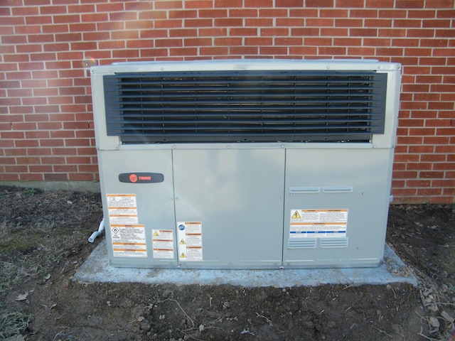 exterior details with brick siding and central AC