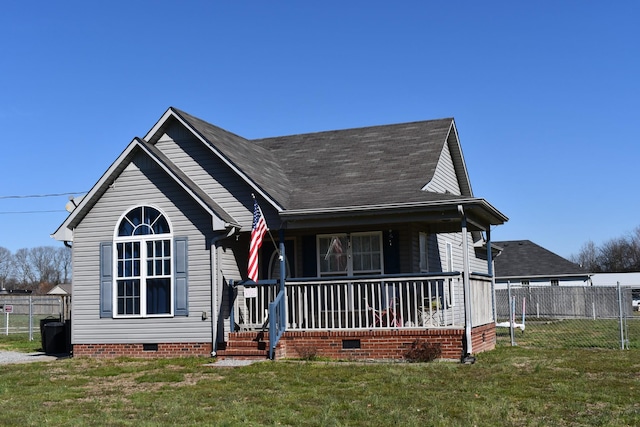 view of front of property featuring covered porch, fence, roof with shingles, crawl space, and a front lawn