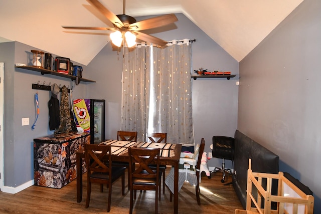 dining space with lofted ceiling, ceiling fan, wood finished floors, and baseboards