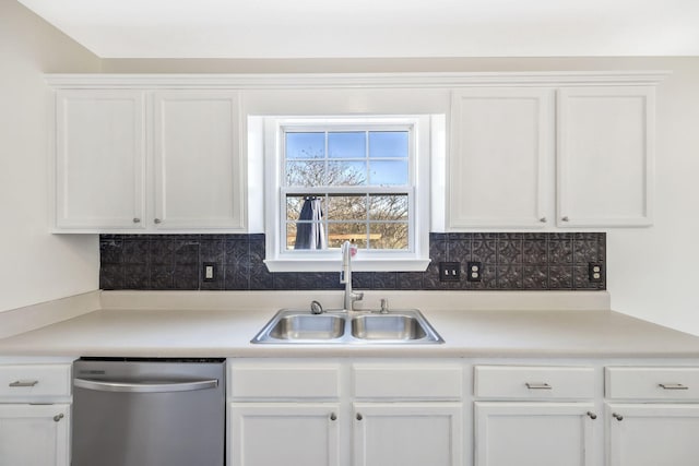 kitchen featuring dishwasher, a sink, and white cabinetry