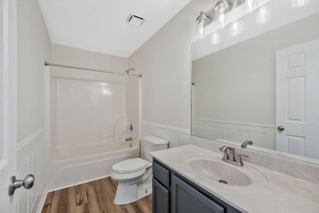 full bath with visible vents, toilet, a wainscoted wall, wood finished floors, and vanity