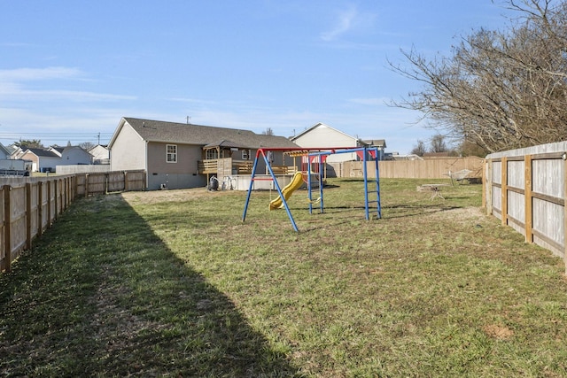 view of yard featuring a fenced backyard and a playground