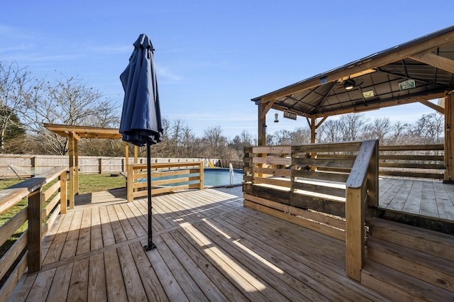 wooden terrace with fence and a gazebo