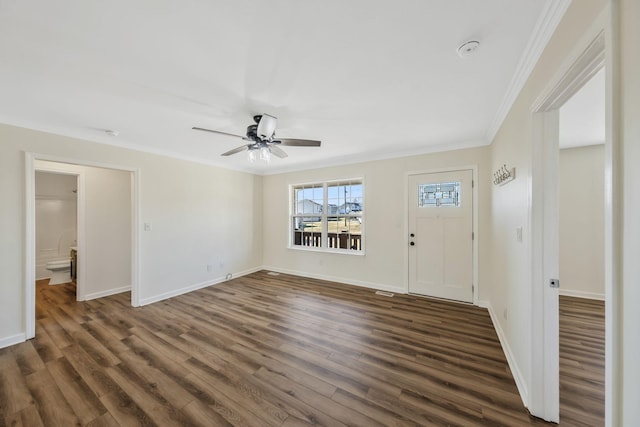 foyer featuring ornamental molding, dark wood-type flooring, ceiling fan, and baseboards