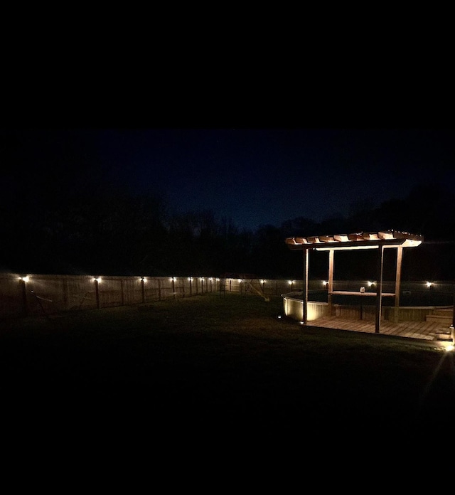 yard at twilight with a pergola