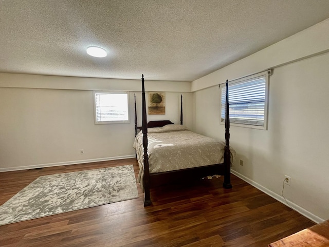 bedroom featuring wood finished floors and baseboards