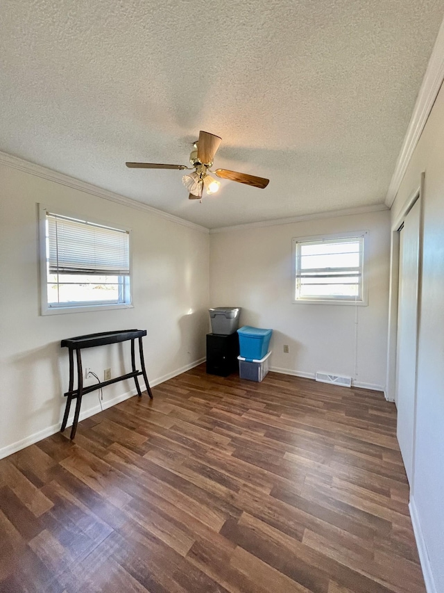 miscellaneous room with crown molding, visible vents, ceiling fan, wood finished floors, and baseboards