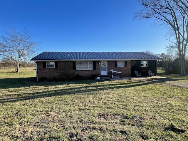 single story home with a front yard, brick siding, metal roof, and entry steps