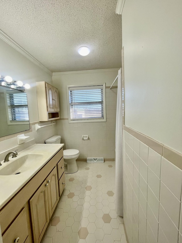 full bathroom featuring toilet, tile walls, a textured ceiling, and tile patterned floors