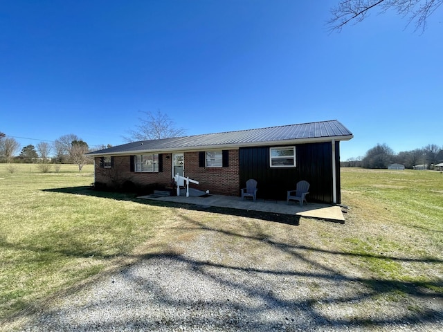 729 Weakley Creek Rd, Lawrenceburg, TN 38464 - view of front of property with brick siding, metal roof, and a front lawn