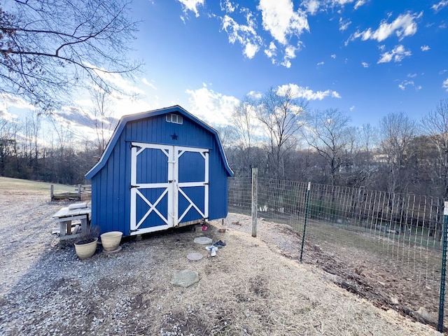 view of shed featuring fence