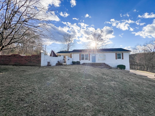 view of front of property with fence and a front lawn