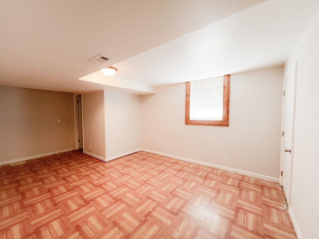 basement featuring visible vents and baseboards