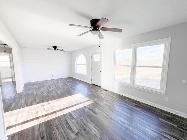 entryway with a ceiling fan, baseboards, and wood finished floors