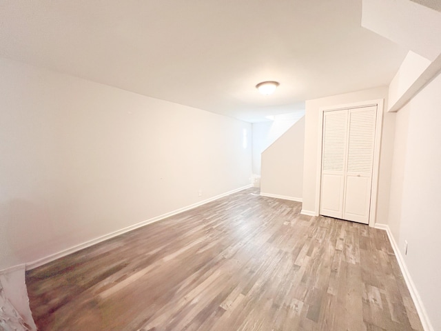 interior space featuring light wood-style flooring and baseboards