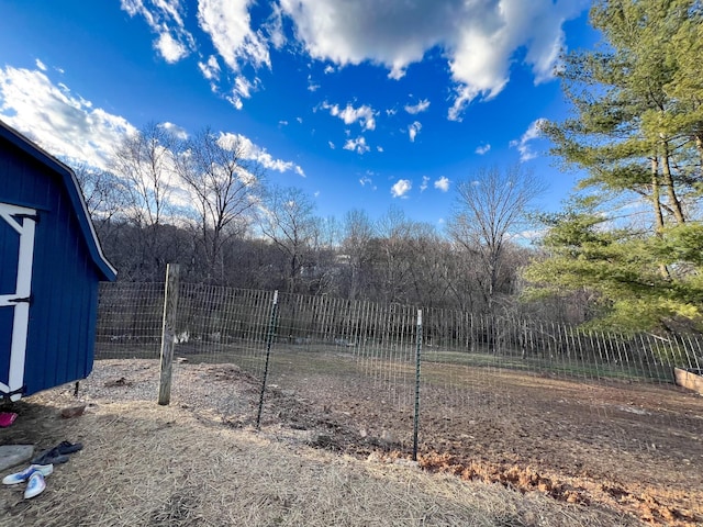 view of yard with an outbuilding and fence