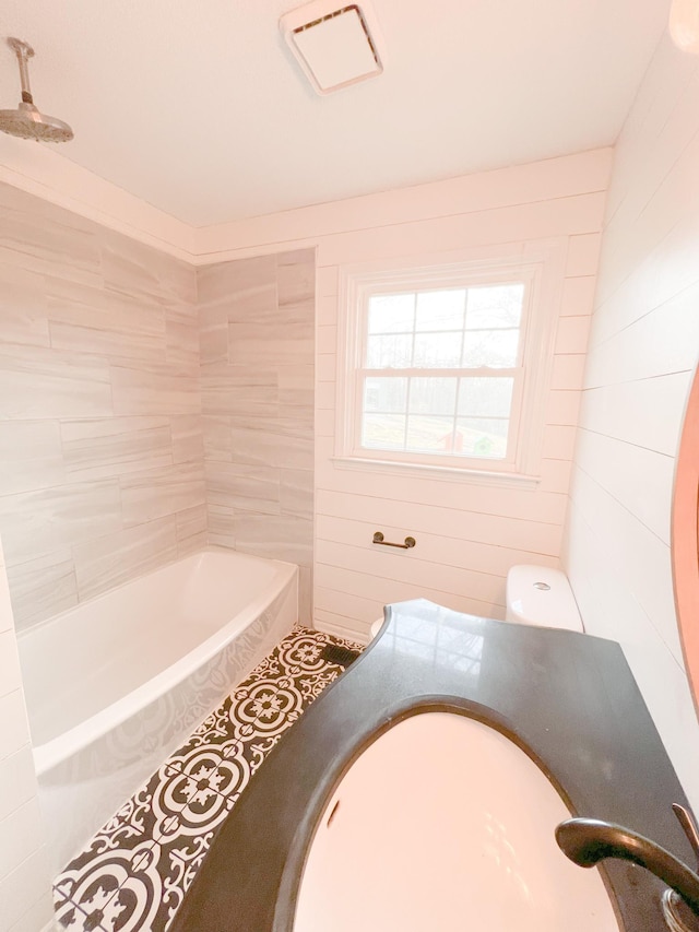 bathroom with a washtub and a shower