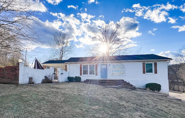 single story home featuring fence and a gate