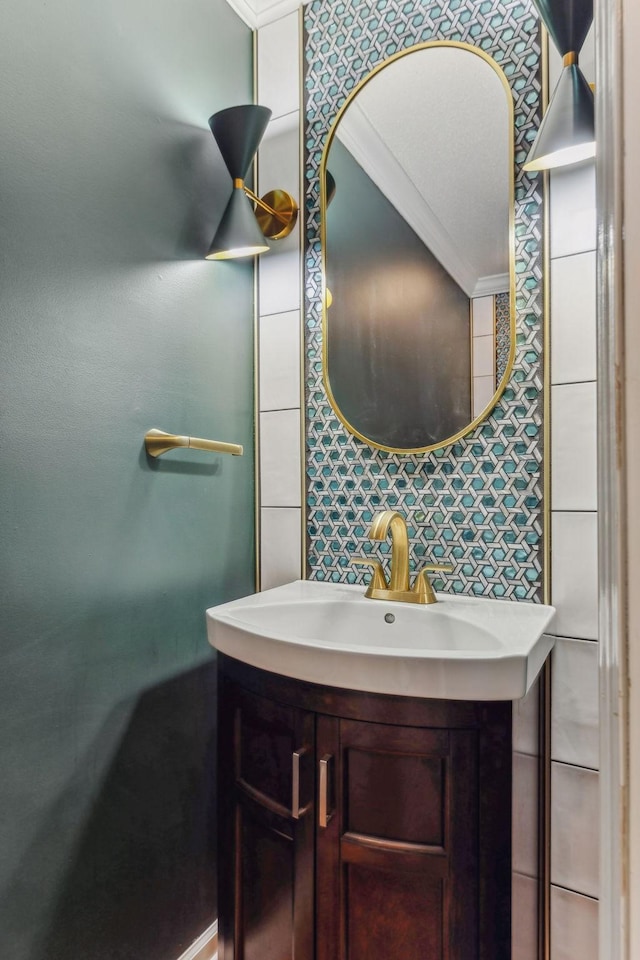 bathroom with ornamental molding, a sink, and decorative backsplash