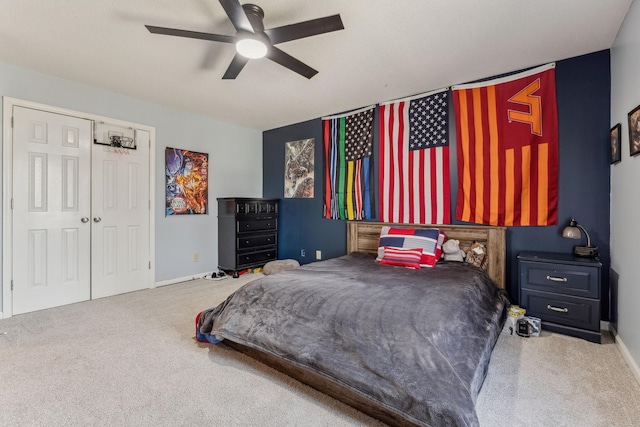 carpeted bedroom with a closet, a ceiling fan, and baseboards