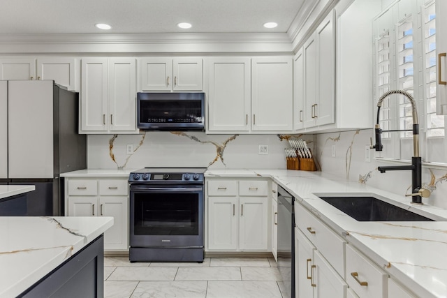 kitchen with white cabinetry, appliances with stainless steel finishes, and a sink