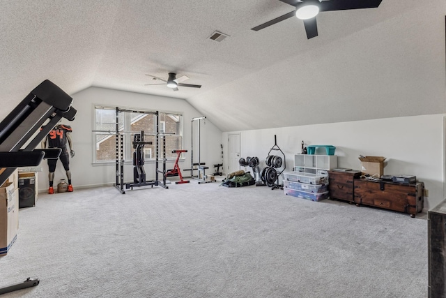 workout room with vaulted ceiling, a textured ceiling, carpet flooring, and visible vents