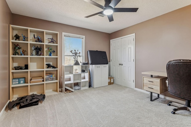 home office featuring a ceiling fan, carpet flooring, a textured ceiling, and baseboards