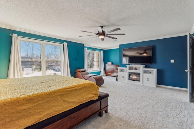 carpeted bedroom with baseboards, ornamental molding, and a glass covered fireplace