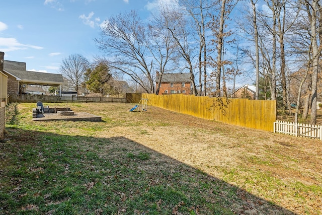 view of yard with a playground and a fenced backyard