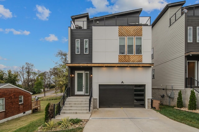 modern home featuring a garage, driveway, and stucco siding