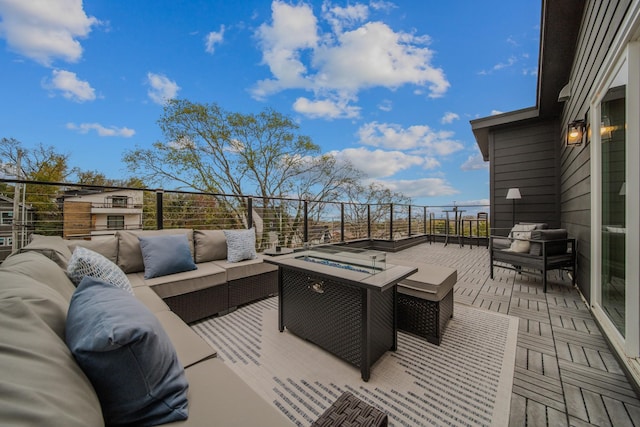 deck with an outdoor living space with a fire pit