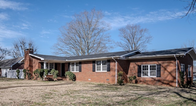 ranch-style home featuring crawl space, a front yard, a chimney, and brick siding