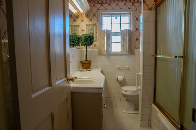 full bathroom with tile walls, wallpapered walls, toilet, vanity, and tile patterned floors