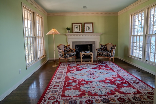 sitting room with dark wood-style flooring, visible vents, a fireplace, and baseboards