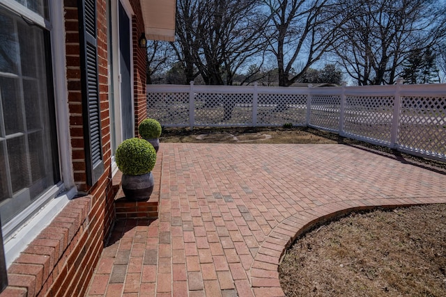 view of patio featuring fence