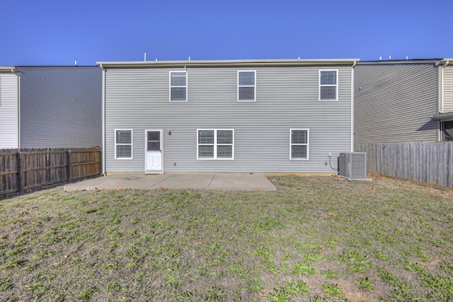 back of property with a yard, a fenced backyard, cooling unit, and a patio