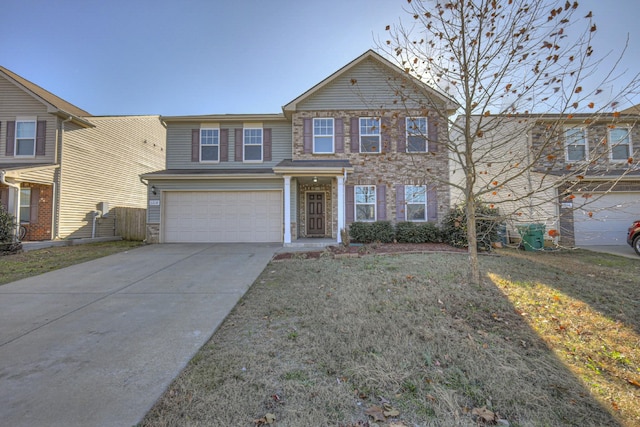 traditional-style home featuring a garage, driveway, a front lawn, and stone siding