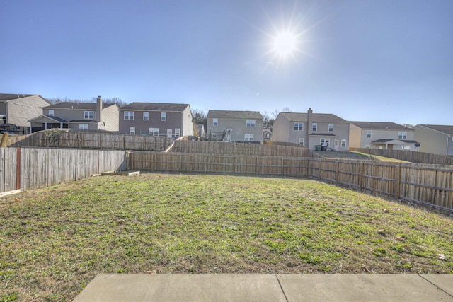 view of yard with a residential view and a fenced backyard