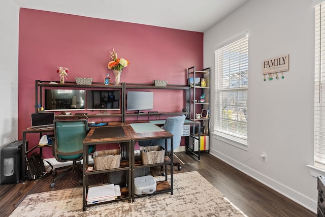 office space with baseboards and wood finished floors