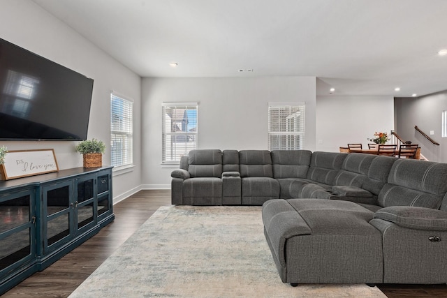 living area with baseboards, stairway, dark wood-type flooring, and recessed lighting