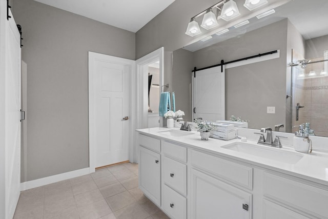 bathroom featuring a tile shower, double vanity, tile patterned flooring, and a sink