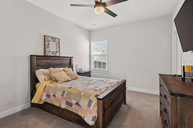 carpeted bedroom with a ceiling fan, visible vents, and baseboards