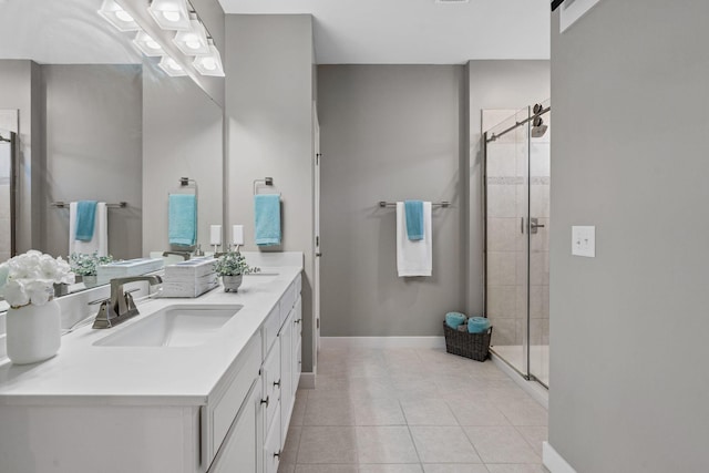 bathroom featuring baseboards, a stall shower, vanity, and tile patterned floors