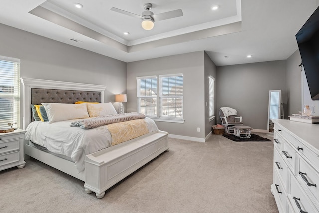 bedroom featuring recessed lighting, a raised ceiling, light colored carpet, and baseboards
