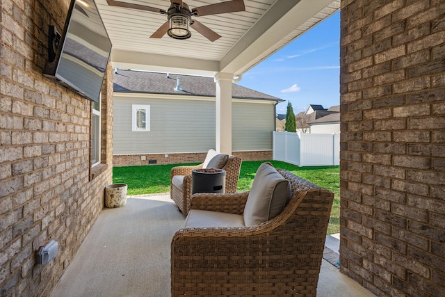 view of patio / terrace with fence and a ceiling fan