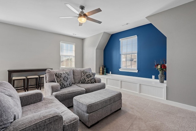 living area with a ceiling fan, carpet, and visible vents