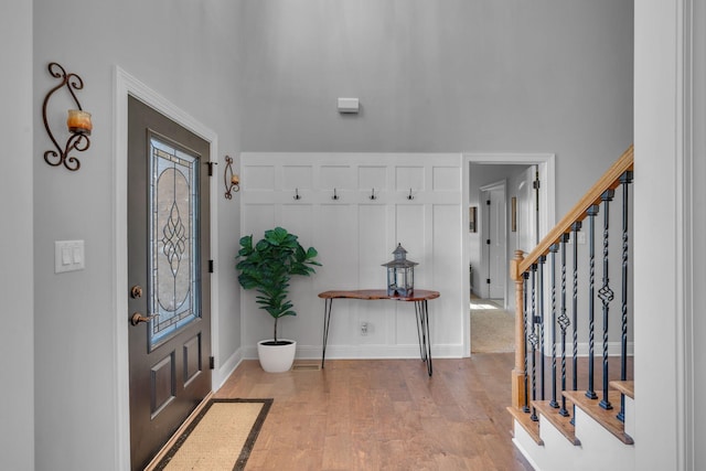 entrance foyer featuring stairs, baseboards, and wood finished floors