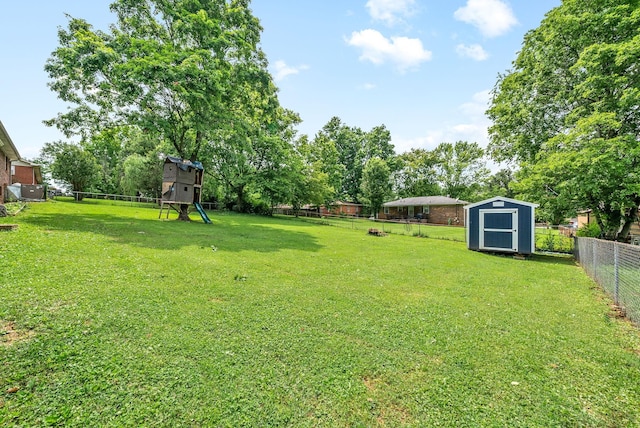 view of yard featuring a fenced backyard, an outdoor structure, and a storage shed