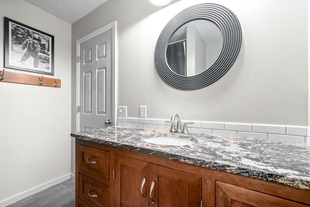 bathroom with tile patterned flooring, vanity, and baseboards