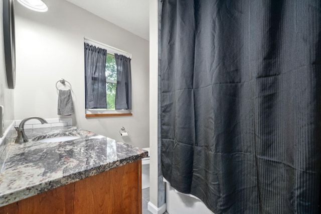 bathroom with curtained shower and vanity